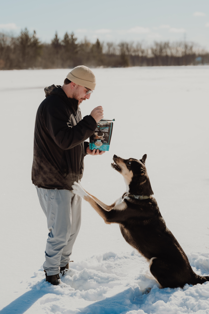 Dog returning to its owner during training and receiving a Grain-Free Salmon with Fruits & Vegetables Oven-Baked Tradition treat