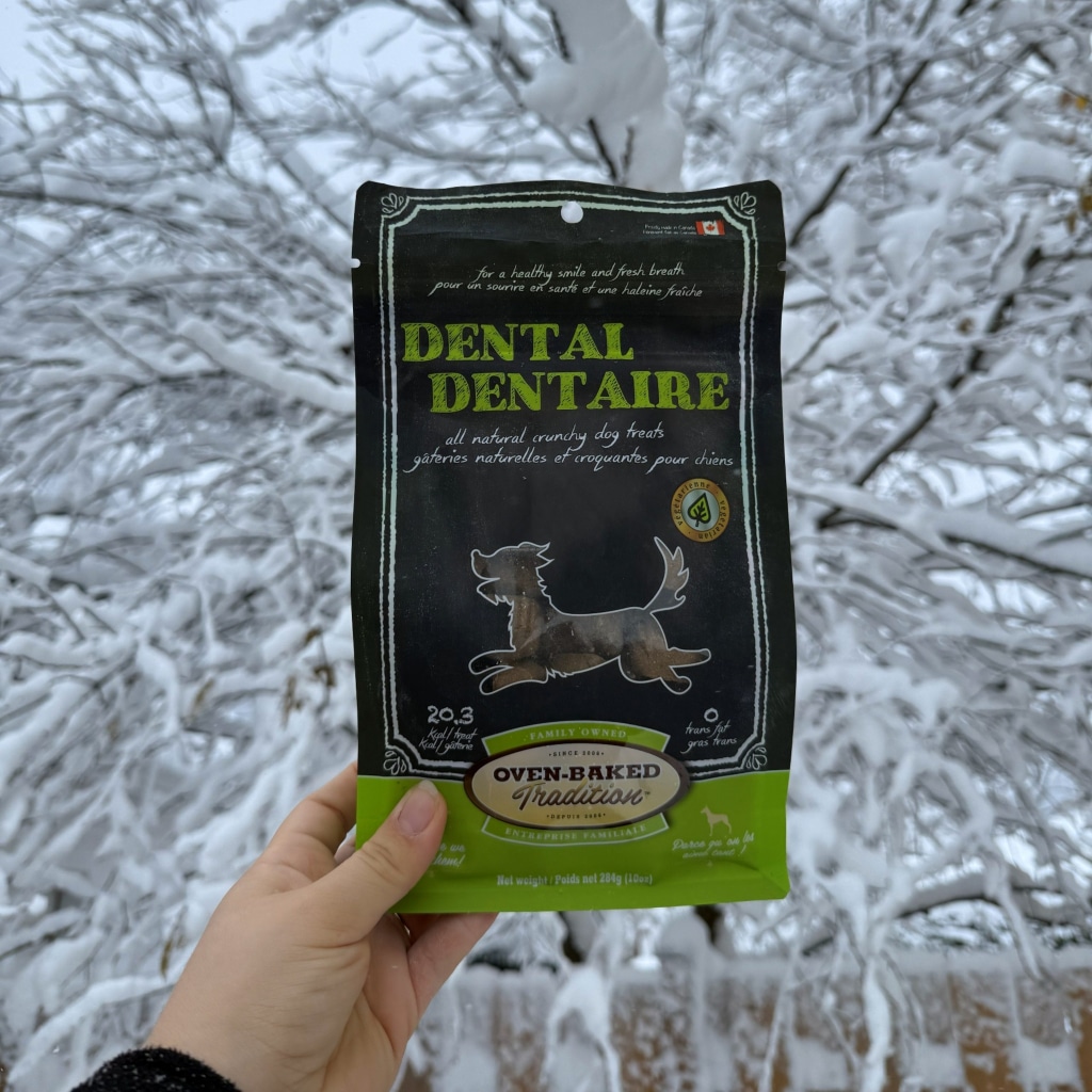 Bag of Oven-Baked Tradition dental treats for dogs in the snow, helps prevent dental and gum problems